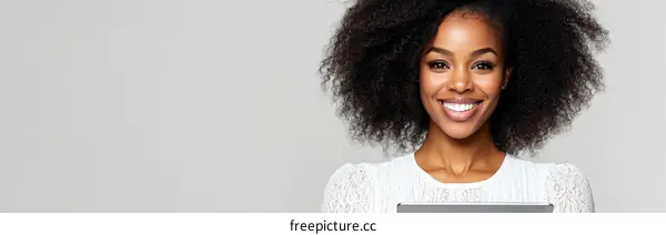 African American Woman Smiling with a Tablet
