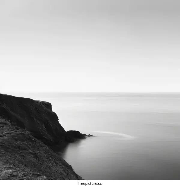 black and white seascape with a cliff