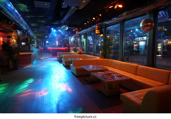 Nightclub Interior with Multicolored Lighting and Sofas