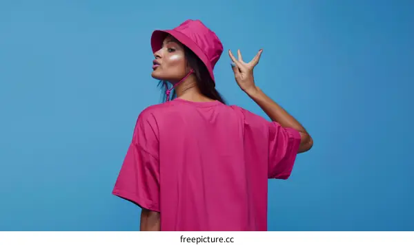 Fashionable Woman in a Pink T-shirt and Hat