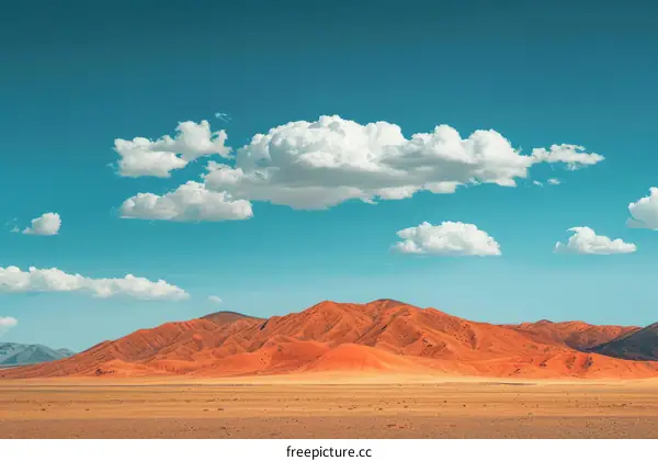 A Desolate Desert Landscape with Distant Mountains Under a Blue Sky
