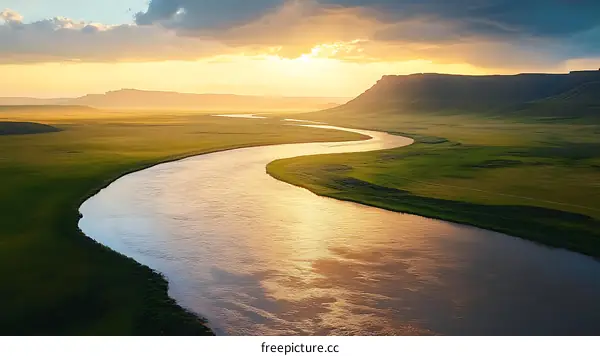 Serene River Winding Through Lush Landscape at Sunset
