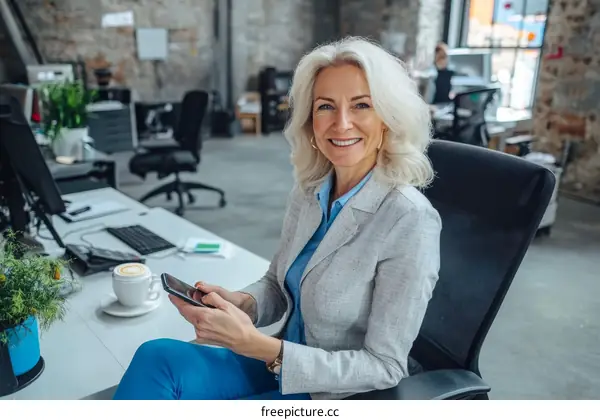 Business Woman Using Smartphone in Modern Office