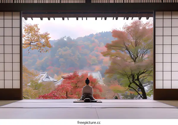 Woman Sitting in a Traditional Japanese House with a View of Autumn Foliage