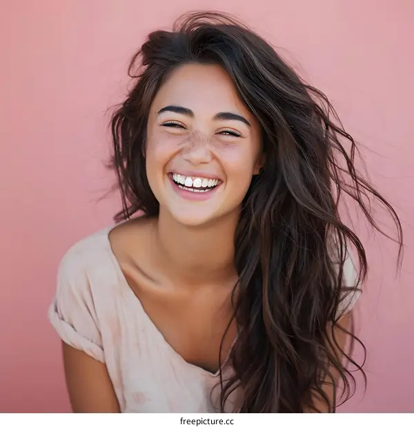 Happy Woman with Freckles Smiling Against Pink Wall