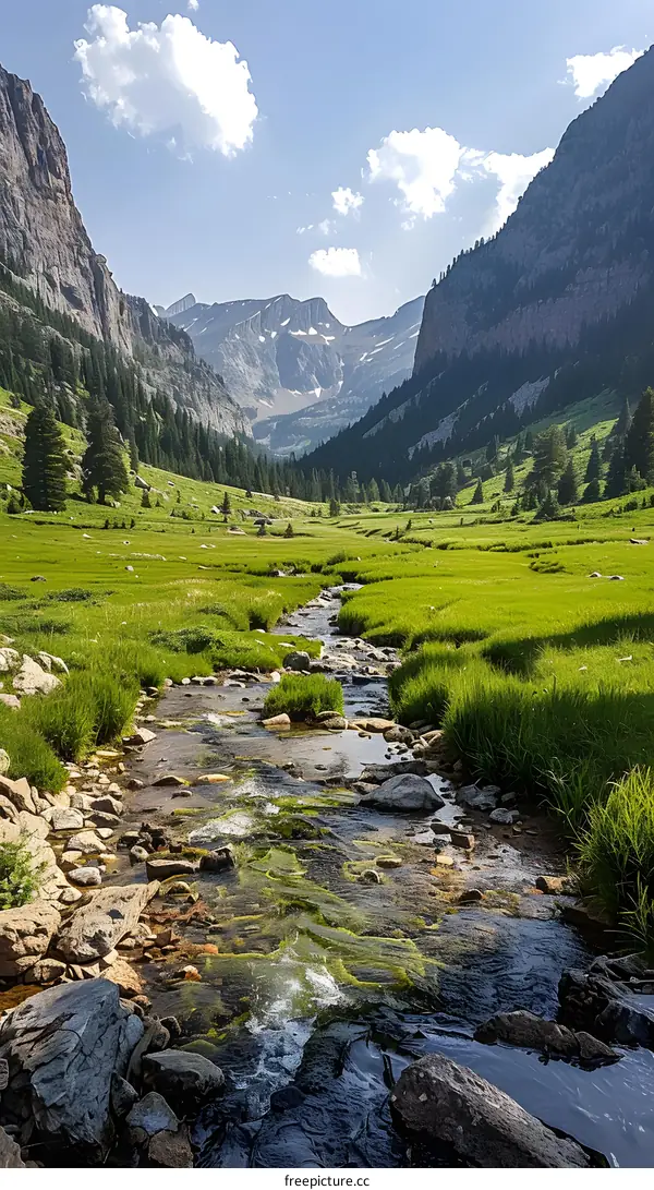 The sun shines through the valley between the mountains