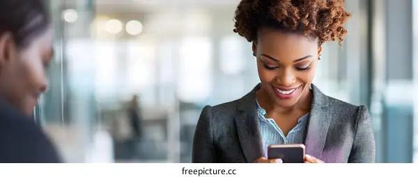 Smiling Black Businesswoman Using Her Phone