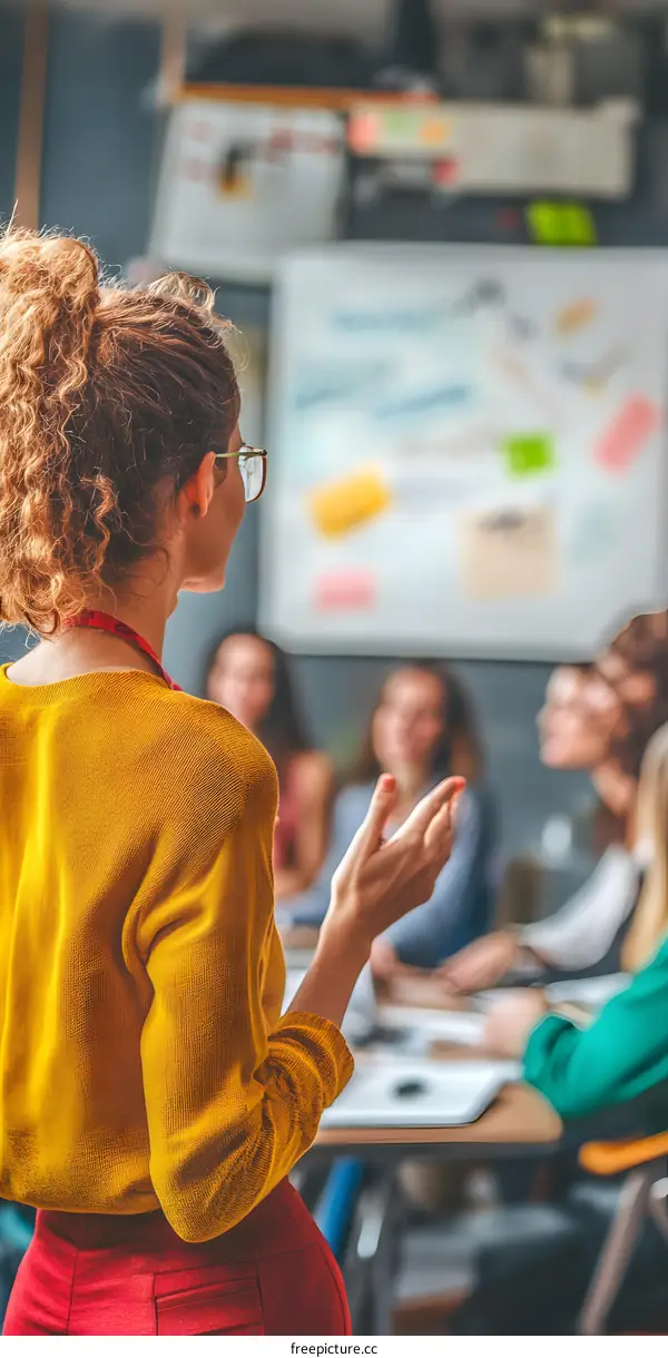 Young Female Speaker Delivering Presentation To Group Of People