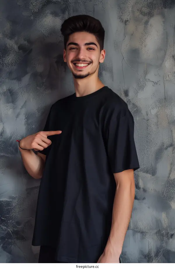 Handsome young man in black t-shirt smiling and pointing at himself