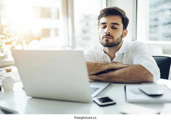 Businessman Relaxing at Office Desk