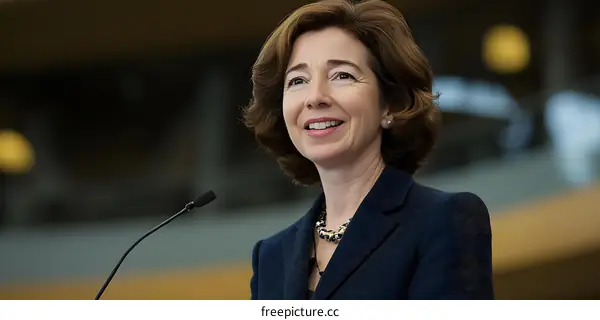 Woman in Blue Suit Giving Speech at Conference