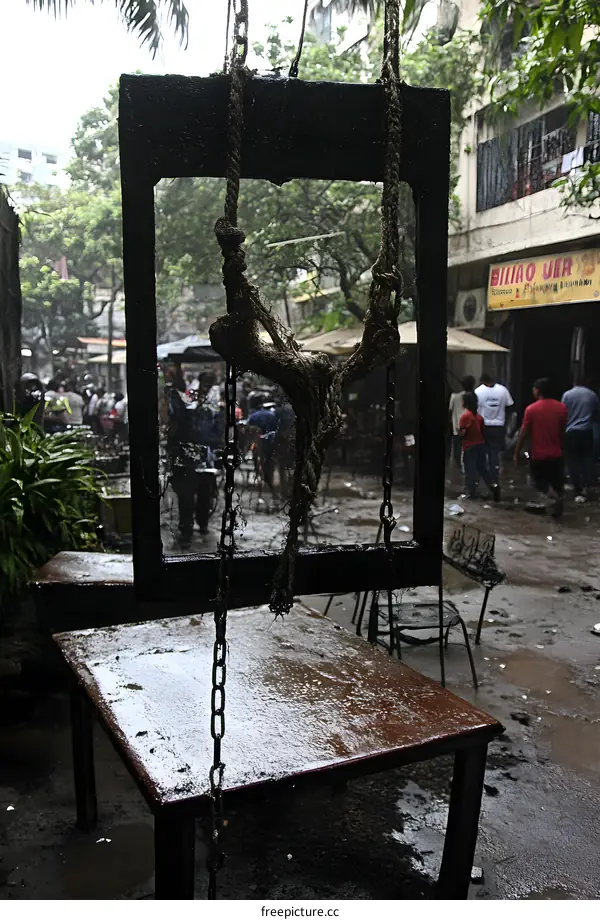 Hanging Rope Swing In Front Of Black Frame In Rainy Day