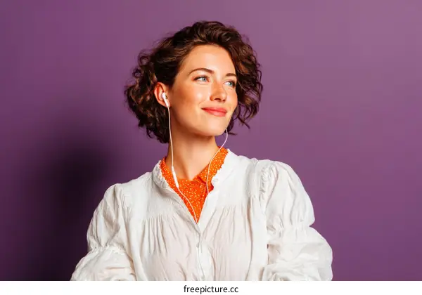 Woman with Headphones in a White Blouse