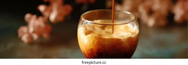 Espresso pouring into a glass of coffee
