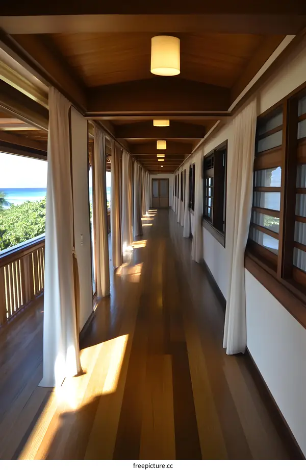 Long Hallway with Wooden Floor and White Curtains