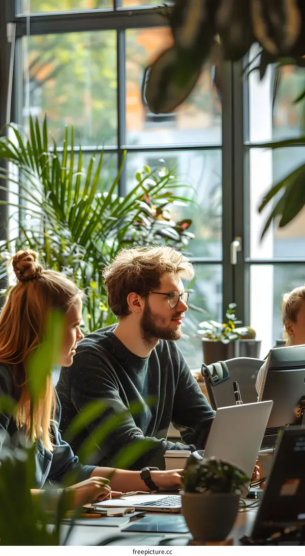A group of people are working in an office.