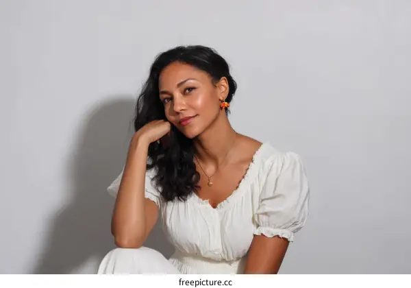 Elegant Woman in a White Dress Studio Portrait