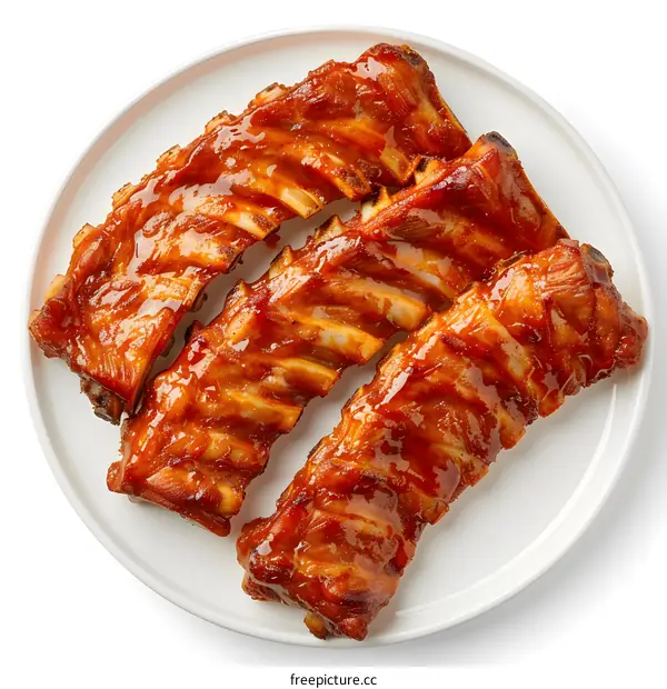 Three pork ribs with barbecue sauce on a white plate