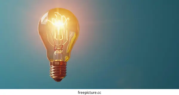 Glowing Light Bulb on Blue Background: Symbol of Ideas and Innovation