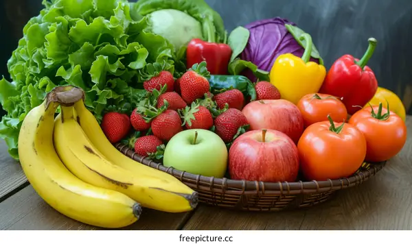 A variety of fresh fruits and vegetables are arranged in a basket and on a wooden table.