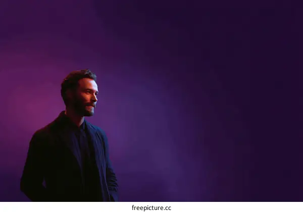 Man standing against vibrant purple background in studio setting