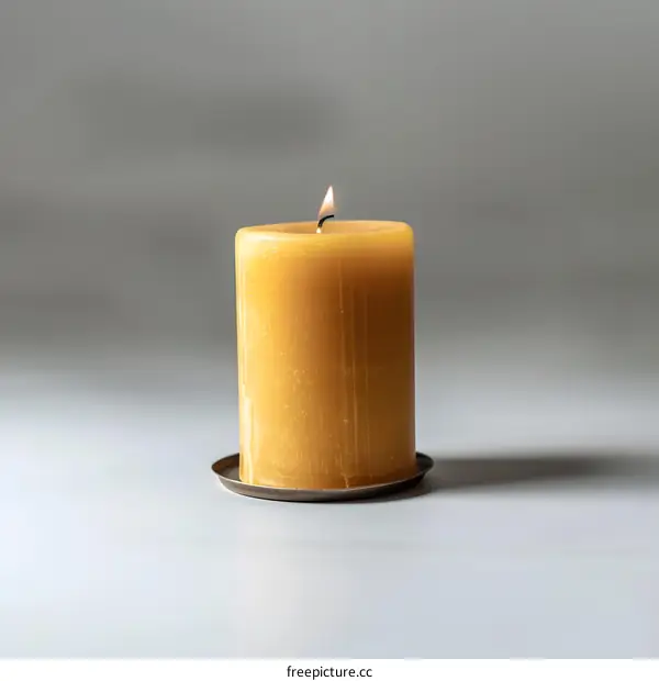 Yellow Candle Flame On White Background