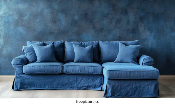 Stylish Dark Blue Sectional Sofa Against Textured Wall