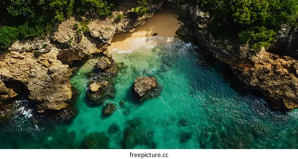 Aerial View of a Secluded Beach Cove Surrounded by Lush Greenery