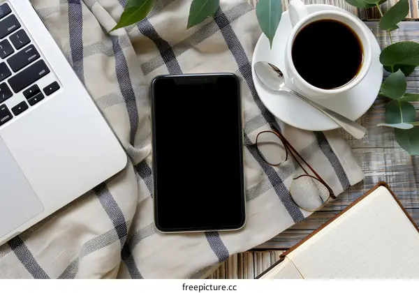 Flat Lay Of Work Space With Coffee Notebook Smartphone And Glasses