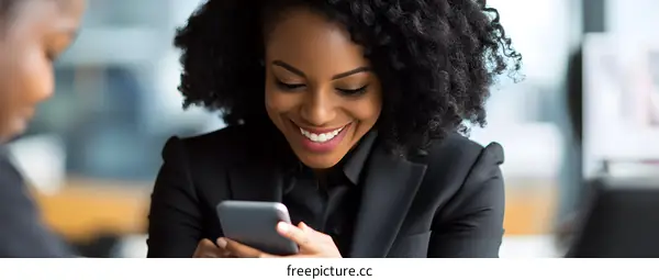 Smiling African American Woman Looking at Smartphone