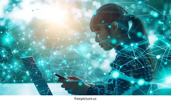 Young Asian Woman Working Remotely on Laptop and Using Smartphone