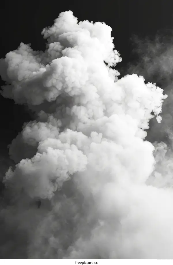White smoke cloud rising up against dark background