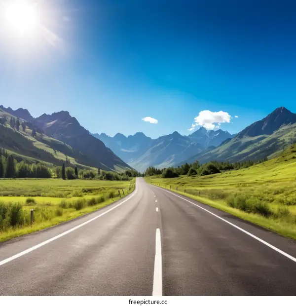 The road is surrounded by high mountains and green fields