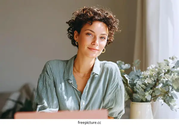 Woman working from home in a light green shirt