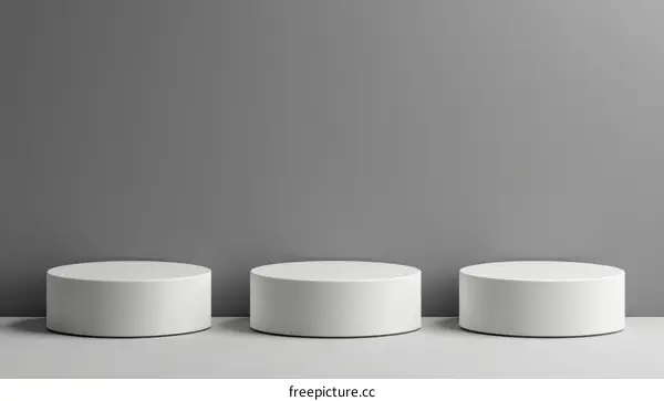 Three White Cylindrical Display Stands