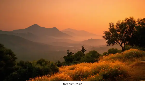 Sunrise over Mountain Ranges with Misty Valley
