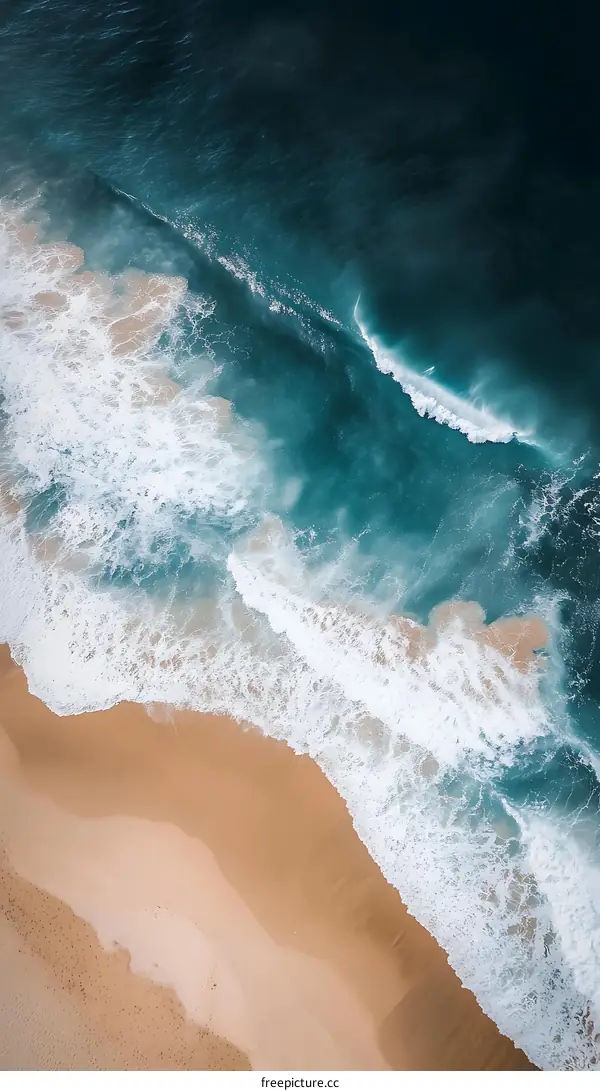 Aerial View of Ocean Waves Crashing on Sandy Beach