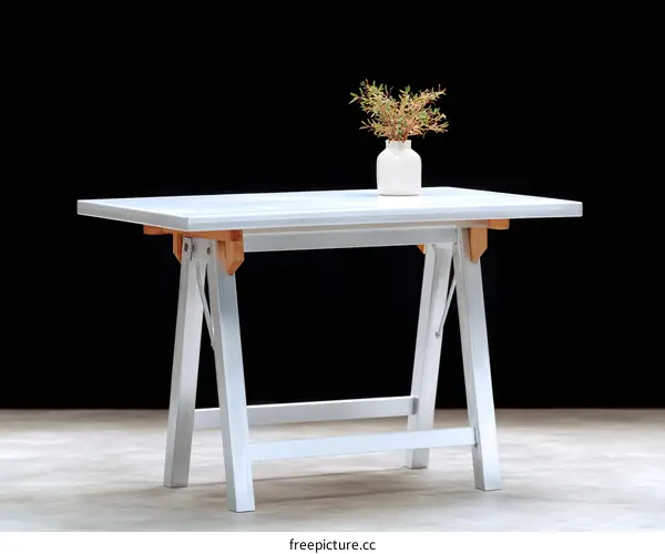 Folding White Wooden Table in Front of Black Background