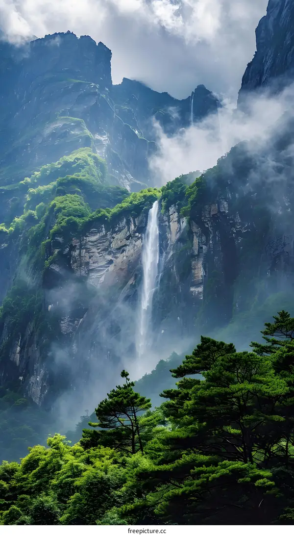 Waterfall Flowing Through Lush Green Mountain Valley