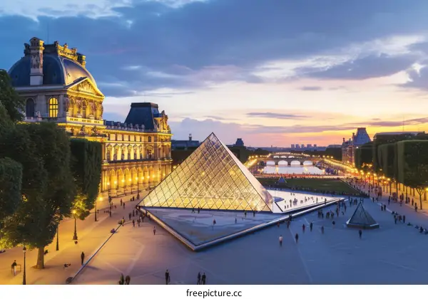 Paris landmarks at sunset with the Eiffel Tower and Louvre Museum
