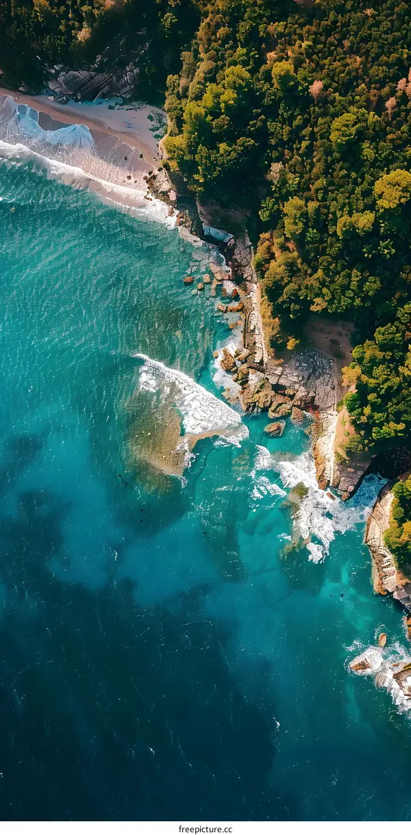 Aerial View of Turquoise Ocean Water Crashing on Rocky Coastline