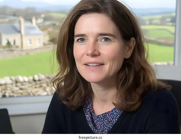 Portrait of a Woman in Front of a Window With a View of a Countryside