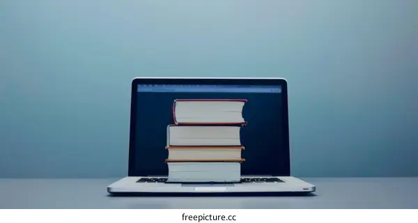 Laptop with Stack of Books on Screen:  Education and Technology