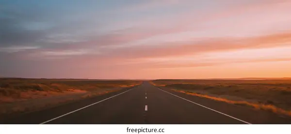 Long Road Under A Colorful Sunset Sky