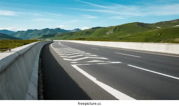 A scenic highway with clear road markings and beautiful mountainous landscape