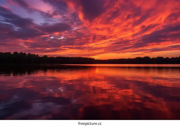 A vivid sunset sky over a calm lake