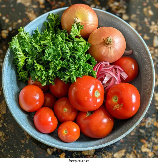 A delicious bowl of tomatoes, red onions, parsley, and spice on a wooden table