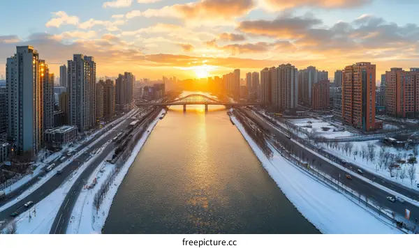 Sunrise over a Snowy City Riverfront
