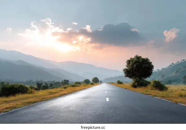 Sunrise Road Through Misty Mountains