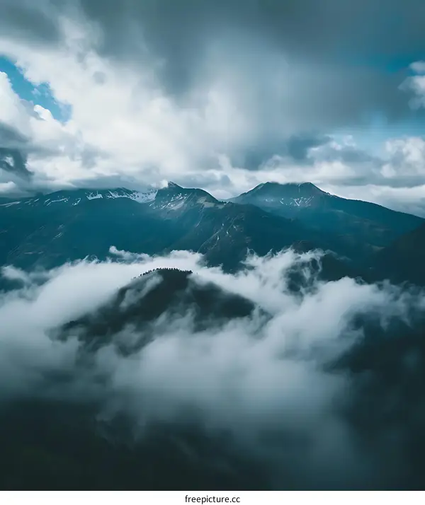 Mountain Peaks Emerging From The Clouds